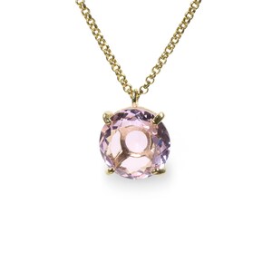May include: A delicate gold chain necklace with a round, light purple gemstone pendant.