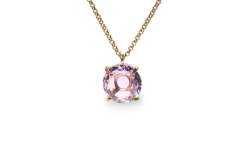 May include: A delicate gold chain necklace with a round, light purple amethyst gemstone pendant.