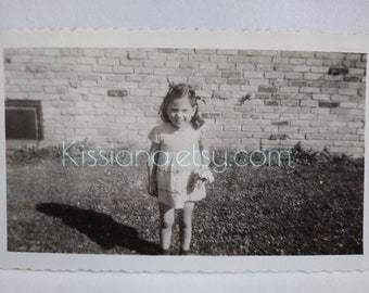 Cute lil girl standing by brick wall--shadow photo,  Vintage B&W photo