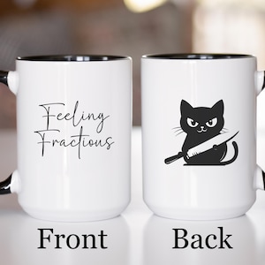 May include: White ceramic mug with a black interior and handle. The front of the mug has the text "Feeling Fractious" in a script font. The back of the mug features a black cat holding a knife. The word "Front" and "Back" are printed at the bottom.