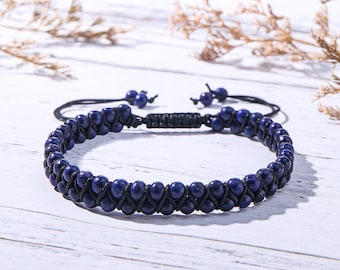 Pode incluir: Uma pulseira de duas fileiras com pequenas contas redondas azul-escuras entrelaçadas com um cordão preto. A pulseira inclui um fecho de nó deslizante ajustável com duas pequenas contas azuis nas pontas dos cordões.