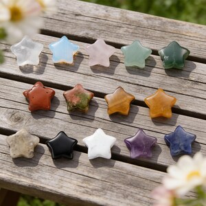 May include: A collection of star-shaped gemstones in various colors, including clear, blue, pink, green, orange, and purple. The gemstones are arranged on a weathered wooden surface, showcasing their unique textures and hues.