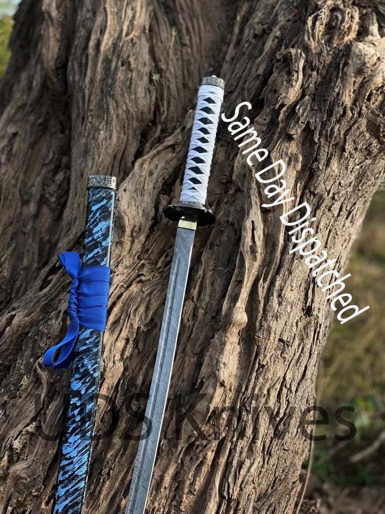 May include: A Japanese katana sword with a white and black handle, a silver blade, and a blue and black scabbard. The text "Same Day Dispatched" is visible on the image.
