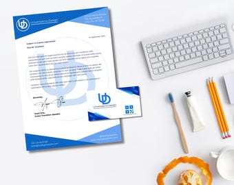 May include: A business stationery set featuring a letterhead and business card with a blue and white design. The letterhead includes the text "Universaenis Design" and contact information. A keyboard, pencils, and a toothbrush are also visible.