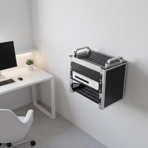 May include: A wall-mounted server rack enclosure featuring a silver metal frame with black side panels, a top ventilation grate, two silver top handles, and an internal shelf holding a white network switch with multiple ports and a power button.
