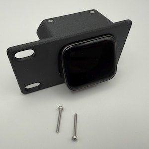 May include: A matte black, 3D-printed mounting bracket featuring a square central housing with a smooth, dark, recessed opening. The bracket includes a flat side flange with two elongated mounting slots and two separate silver metal screws.