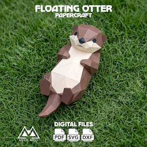 May include: A low-poly papercraft model of a floating otter with brown and cream geometric panels. The text FLOATING OTTER PAPERCRAFT and DIGITAL FILES PDF SVG DXF is visible. The otter has a dark nose and eyes, with a light-colored belly.