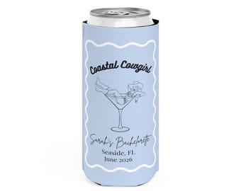 May include: A light blue slim can cooler featuring a white scalloped border and a black line art graphic of a person in a cowboy hat lounging in a martini glass. The text reads Coastal Cowgirl, Sarah's Bachelorette, Seaside, FL, June 2026.