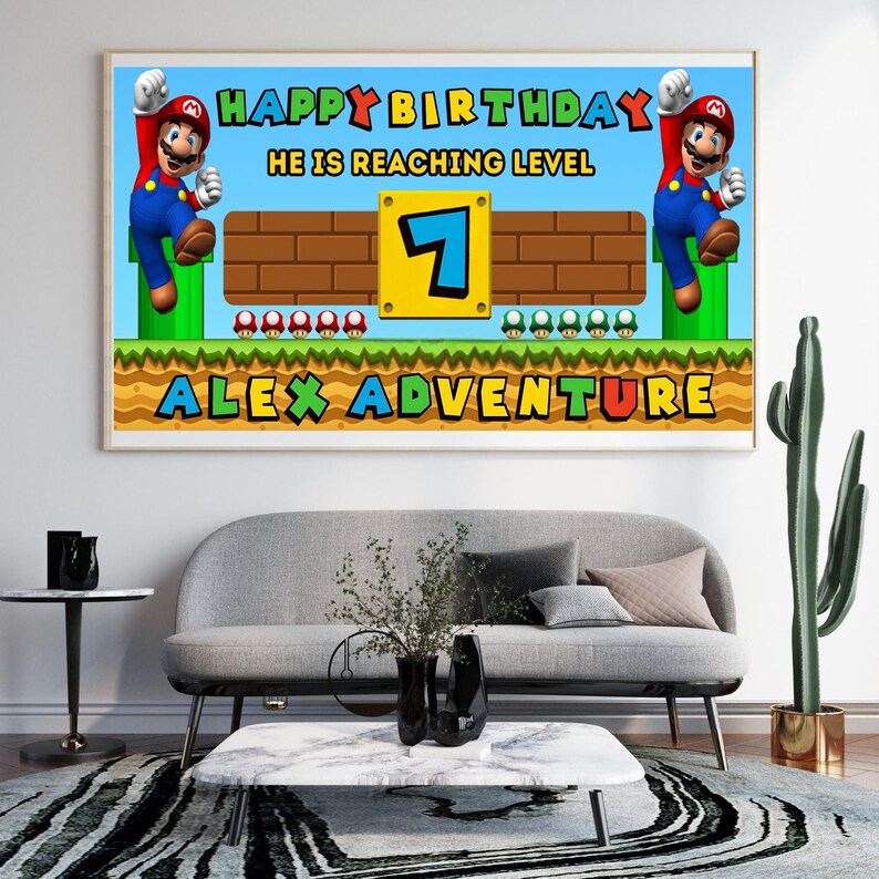 May include: A framed birthday banner featuring a Super Mario theme. The banner reads "Happy Birthday, He is Reaching Level 7, Alex Adventure" with Mario characters and game elements. The banner is displayed above a gray sofa.