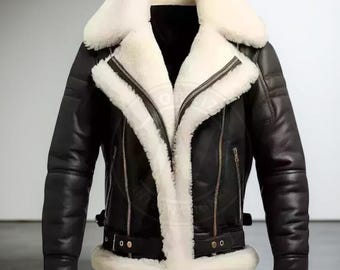 May include: Black leather jacket with a white shearling collar and lining. The jacket features a zip-up front, side pockets, and a buckled belt at the waist. The sleeves have a ribbed design and cuffs with white shearling trim. A classic outerwear piece.