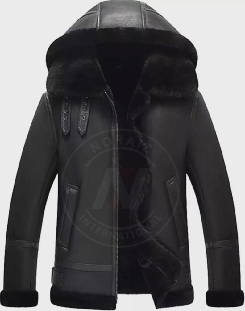 May include: Black leather jacket with a hood and a fur-lined interior. The jacket features a zipper closure, two front pockets, and buckle details on the sleeves. The jacket is designed for cold weather.