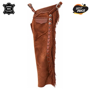 May include: A brown suede leather chap featuring a long fringe along the side, a small pocket with a flap, and a buckled belt at the top. The side panel is decorated with silver-toned metal studs and a braided leather trim detail along the waist.