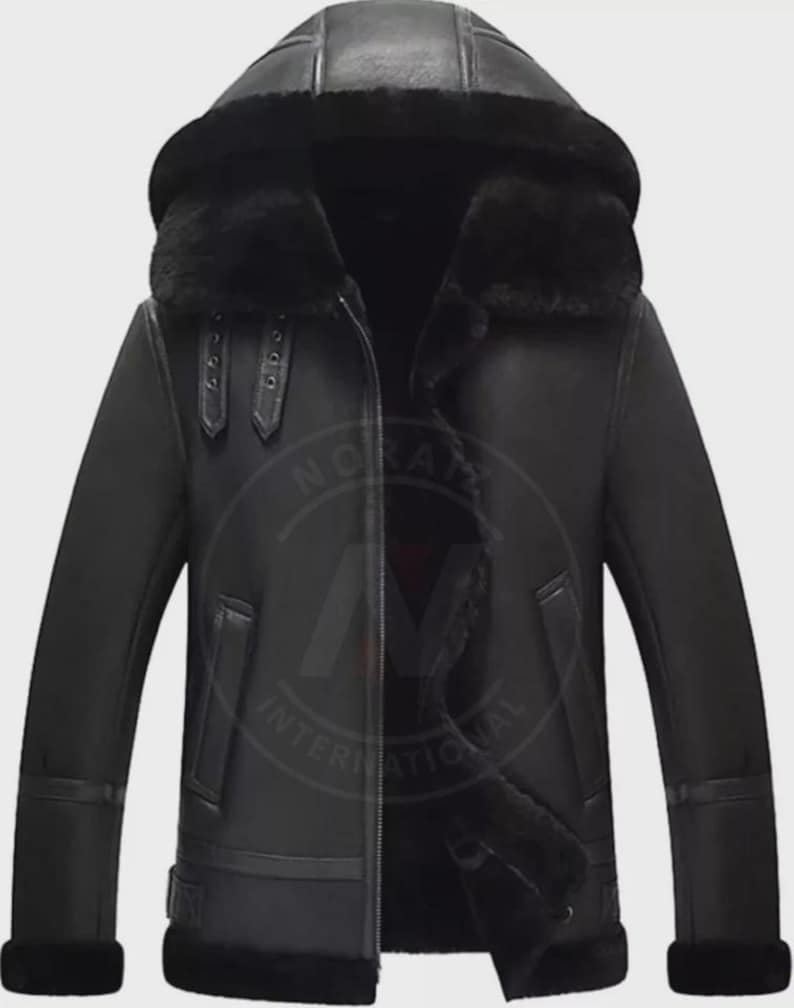 May include: Black leather jacket with a hood and a fur-lined interior. The jacket features a zipper closure, two front pockets, and buckle details on the sleeves. The jacket is designed for cold weather.