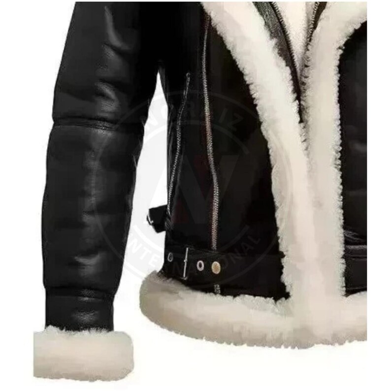 May include: Black leather jacket with a white shearling lining and trim. The jacket features a zipper closure, a buckled belt detail, and a classic aviator style. The sleeves are long and the cuffs are trimmed with white shearling.