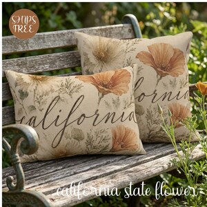 May include: Two rectangular and square throw pillows made of beige fabric featuring a botanical print of orange California poppies and green foliage. The word California is written in a dark brown cursive script across the front of each pillow.