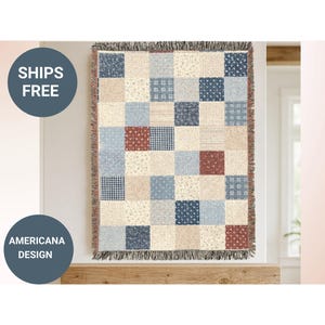 May include: Americana design throw blanket with a patchwork pattern. The blanket features squares in shades of blue, red, and beige with floral and plaid designs. The blanket has a fringed edge.