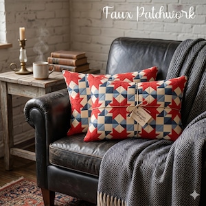 May include: Two rectangular throw pillows with a faux patchwork design. The pillows feature a pattern of red stars, blue squares, and cream-colored blocks. They are tied together with twine and a tag. The pillows rest on a black leather armchair.