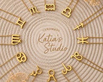 May include: A collection of twelve gold-toned metal necklaces, each featuring a unique zodiac symbol pendant. The necklaces are arranged in a circular pattern around the central text "HANDMADE Katia's Studio" printed in a cursive font.