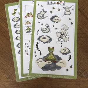 May include: Three sticker sheets with a green border. The stickers feature cartoon frogs, clouds, and speech bubbles with phrases like "PSSHH" and "PFFSSS." The text "Magical Menagerie of Gas" is visible.