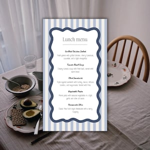 May include: A lunch menu card with a blue and white striped background and a decorative blue border. The menu lists Grilled Chicken Salad, Tomato Basil Soup, Club Sandwich, Vegetable Pasta, and Cheesecake Slice.