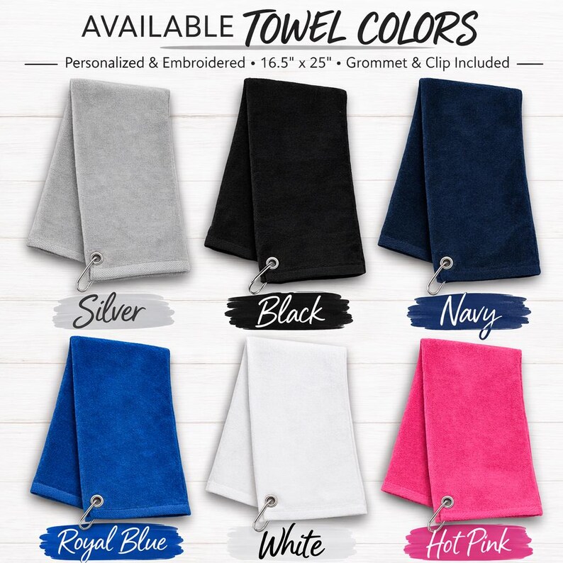 May include: A display of six folded towels in various colors: silver, black, navy, royal blue, white, and hot pink. Each towel has a metal grommet and clip. The text "AVAILABLE TOWEL COLORS" is at the top.