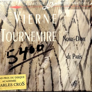 May include: A CD album cover with the text "Vierne Tournemire Notre-Dame de Paris" and the handwritten number "5400". The background features a feather pattern. The album also displays the text "Grand Prix Du Disque Academie Charles Cros".