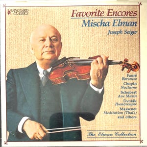 May include: Album cover featuring Mischa Elman playing a violin. The title "Favorite Encores" is displayed in red and blue, with a list of musical pieces. The Elman Collection is also noted. The image has a vintage aesthetic.