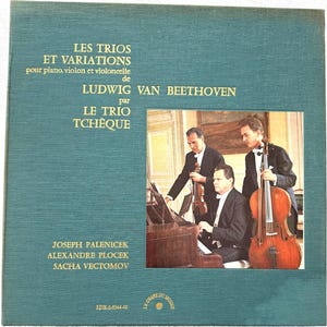 May include: A teal-coloured album cover with the text "LES TRIOS ET VARIATIONS" and musician names. A photograph shows three men in formal attire, one playing the piano, another the violin, and the third the cello. The album is by Le Trio Tchèque.