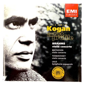 May include: A vintage album cover featuring a black and white portrait of Leon Kogan. The cover includes the text "Kogan artist profile" and lists violin concertos by Brahms, Beethoven, and Tchaikovsky. The EMI Classics logo is visible.