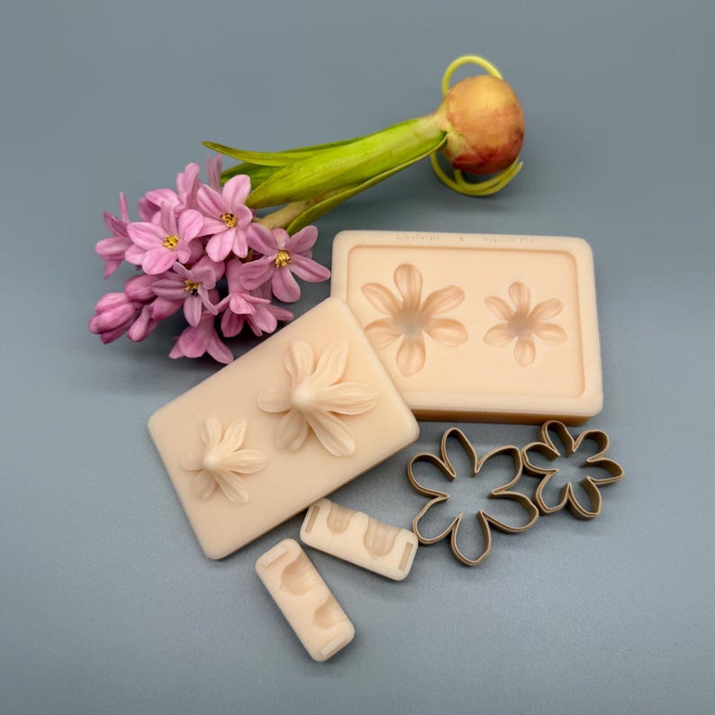 Hyacinth flower platinum silicone mold set with petal veiner molds, bud molds, flower center mold, leaf mold and bulb mold with matching cutters, botanical texture molds for creating realistic hyacinth flowers from polymer clay, flexible non-stick reusable silicone molds for detailed clay flowers, ideal for floral jewelry, botanical sculptures and DIY clay flower making.