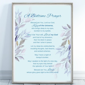 May include: Framed print with a light blue background and the text "A Bedtime Prayer." The text is surrounded by watercolor-style illustrations of leaves in shades of purple and gold. The prayer is written in a decorative font.