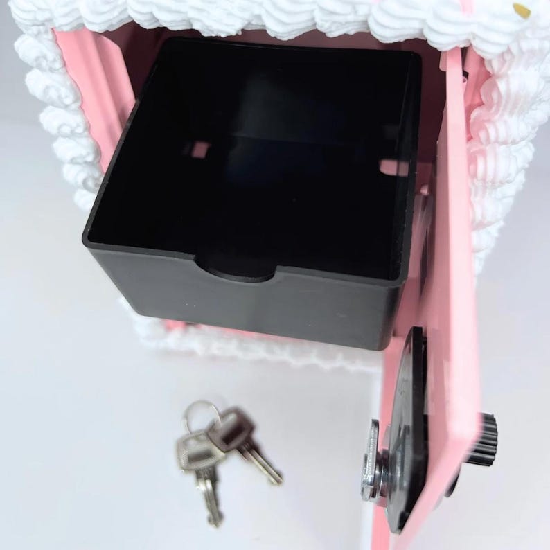 Close-up of the inside compartment of the pink cake vault mini locker, showing coin basket and roomy space for cash, jewelry, or small treasures.