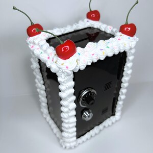 Side view of the black cake vault mini locker showing durable iron alloy build and frosting details.
