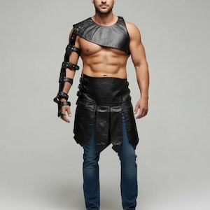 May include: A black leather chest and arm armor set with studded details. The set includes a shoulder piece, arm guards, and a skirt-like bottom. The model is wearing blue jeans. This is a costume or cosplay item.