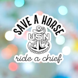 May include: A white sticker with a black anchor design, chain, and the text "SAVE A HORSE ride a chief". The letters "USN" are in the center of the anchor. The background is a blurred mix of colors.