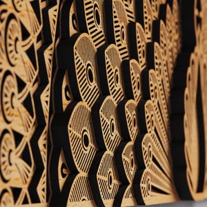 May include: A layered wooden wall art piece featuring a peacock feather design. The artwork has a natural wood color with black accents, creating a three-dimensional effect. The intricate cut-out patterns add depth and visual interest.