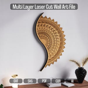May include: A multi-layer laser-cut wall art piece in a half-circle design, featuring intricate patterns and details. The artwork is made of light brown wood and hangs on a white wall. The text "Multi Layer Laser Cut Wall Art File" is at the top.