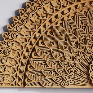 May include: A detailed wooden peacock feather design, laser-cut with intricate patterns. The artwork features a fan-shaped arrangement of feathers with eye-like details and geometric shapes. The natural wood color and layered construction create a 3D effect.