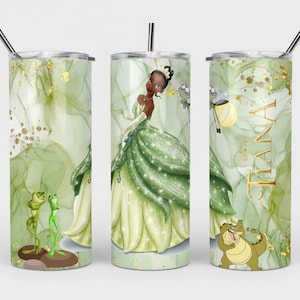 May include: A set of three stainless steel tumblers with lids and straws. Each tumbler features a different design: a princess in a green gown, the name "TIANA" in gold, and cartoon frogs and a crocodile. The background has a green and gold watercolor effect.