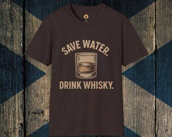 May include: A brown t-shirt featuring the slogan "SAVE WATER. DRINK WHISKY." in a light brown font. The design includes a graphic of a whisky tumbler. The shirt has a round neck and short sleeves.