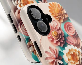 Può includere: Primo piano di due custodie per telefoni con un design floreale. Le custodie presentano uno sfondo rosa chiaro con fiori colorati nelle tonalità del rosa, dell'arancione e del bianco. La custodia del telefono a destra ha un obiettivo nero.