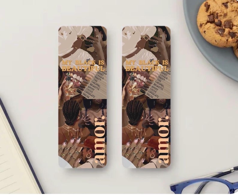 May include: Two rectangular bookmarks featuring a collage of illustrations depicting Black individuals with various skin tones, hairstyles, and jewelry. The text "MY BLACK IS BEAUTIFUL" and "amor" is printed in a bold, gold-toned font on each bookmark.