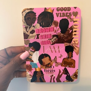 May include: A pink rectangular art print with illustrations of Black women. The design includes text such as "Brown Skin Girl", "Good Vibes", "I Am Beautiful", and "Don't Forget Your Amor". The print features various hairstyles and accessories.