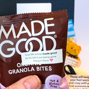 Puede incluir: Una bolsa marr&oacute;n de granola org&aacute;nica "MADE GOOD". La bolsa tiene texto blanco y una peque&ntilde;a pegatina con un mensaje. Tambi&eacute;n son visibles las palabras "sin nueces y sin gluten".