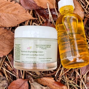 May include: A jar of Puretone Brightening Cream and a bottle of Puretone Brightening Serum, both with yellow liquid, sit on a bed of autumn leaves. The cream is 2.3 oz, and the serum is 2.0 oz. Both products are infused with licorice root extract.