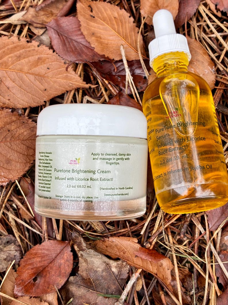 May include: A jar of Puretone Brightening Cream and a bottle of Puretone Brightening Serum, both with yellow liquid, sit on a bed of autumn leaves. The cream is 2.3 oz, and the serum is 2.0 oz. Both products are infused with licorice root extract.