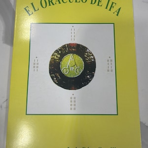 May include: A book titled "EL ORÁCULO DE IFA" with a yellow cover. The title is in green, and the cover features a central circular design with a yellow and green emblem. The author's name, Luis Díaz Castillo, is at the bottom.