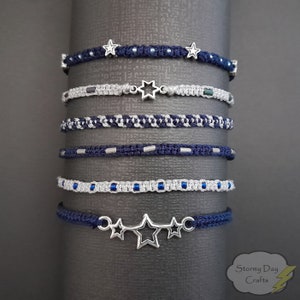May include: A set of six blue and silver friendship bracelets with star and star of David charms. The bracelets are made with different patterns and textures.