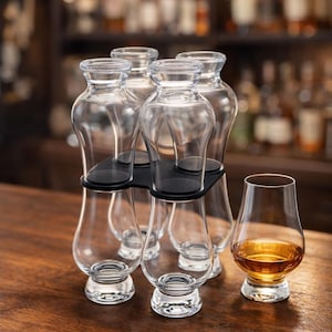 May include: A clear glass Glencairn whisky glass with amber liquid next to a black glass holder with 8 Glencairn glasses. The text "Holds 8 Glencairn Glasses" is in an orange rectangle.
