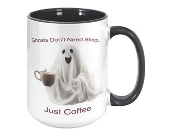May include: White ceramic coffee mug with a black interior and handle. The mug features a smiling ghost illustration holding a coffee cup, with the text "Ghosts Don't Need Sleep... Just Coffee."